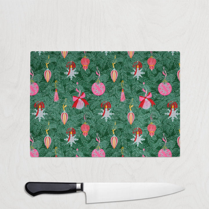 Cutting board with fairy and flower pattern on a white surface with a knife.