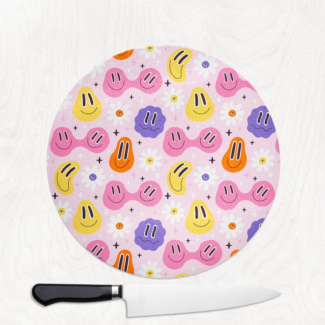 Round cutting board with colorful smiley face pattern on a white background