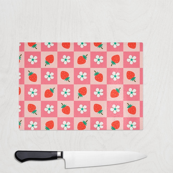 Pink strawberry and daisy flower checkerboard print glass chopping board