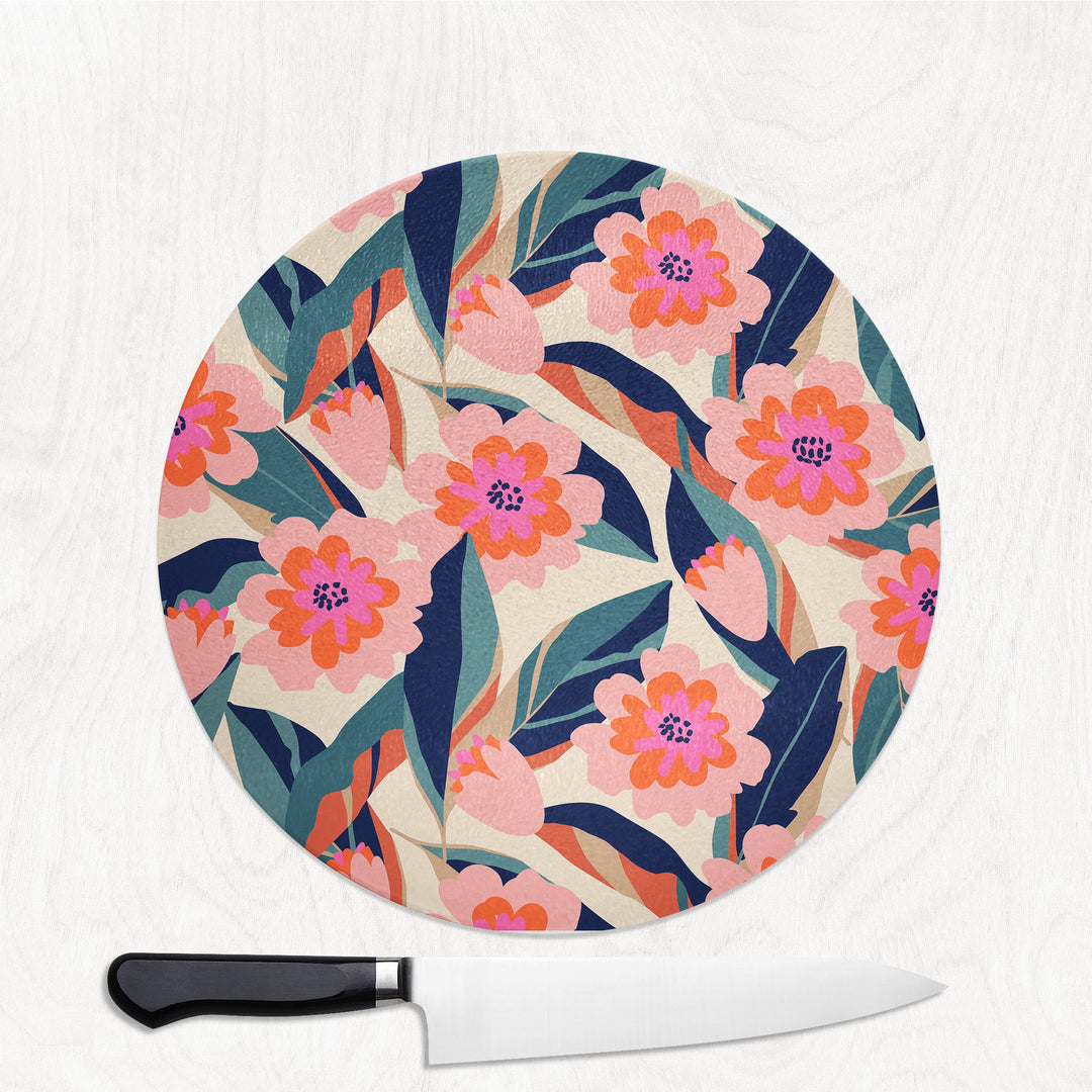 Round cutting board with floral pattern and a knife on a white background