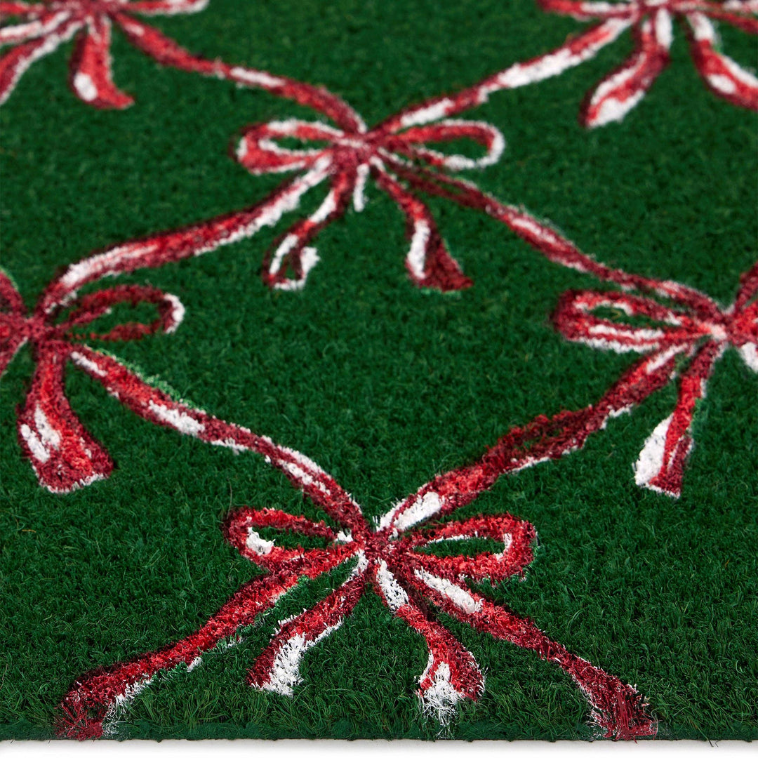 Green fabric with red and white bows pattern door mat