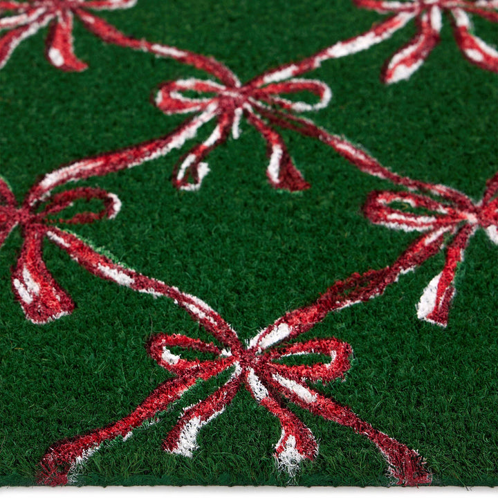 Green fabric with red and white bows pattern door mat