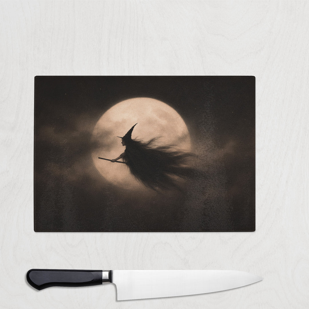 Broom Witch And Moon glass chopping board with a witch in full flight silhouetted against a giant full moon