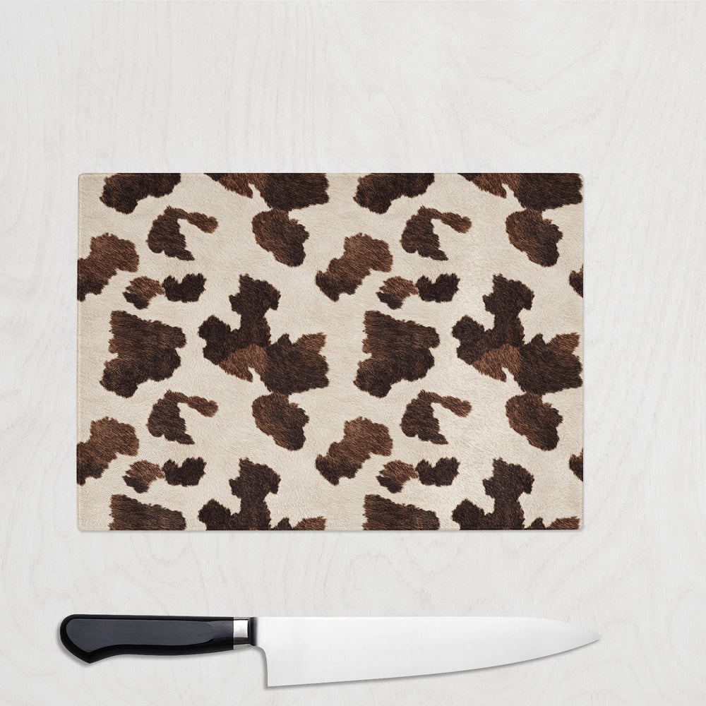 Brown Leopard print cutting board with a knife on a white background