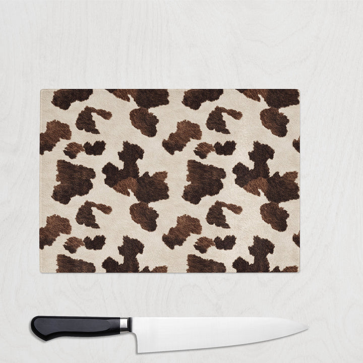 Brown Leopard print cutting board with a knife on a white background