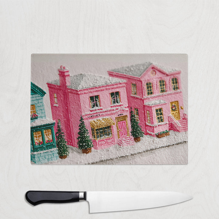 Embroidered picture of a pink house with a knife on a white background