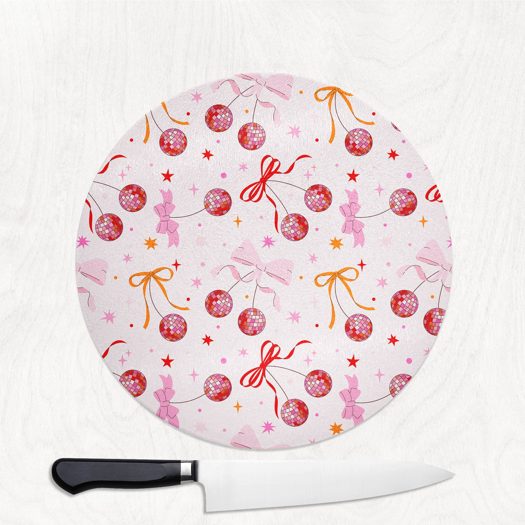 Round cutting board with decorative pattern and a knife on a white background