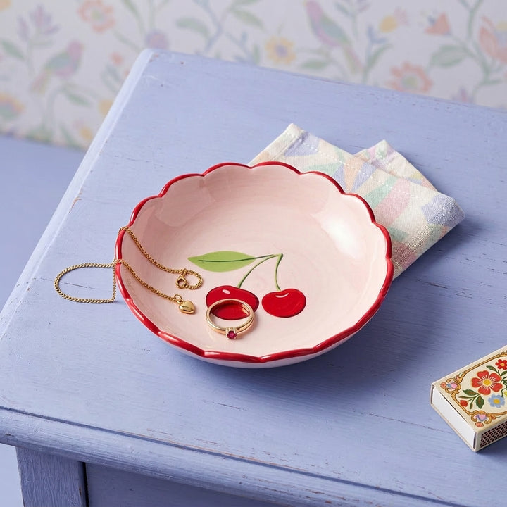 Cherry trinket dish on a lilac table 
