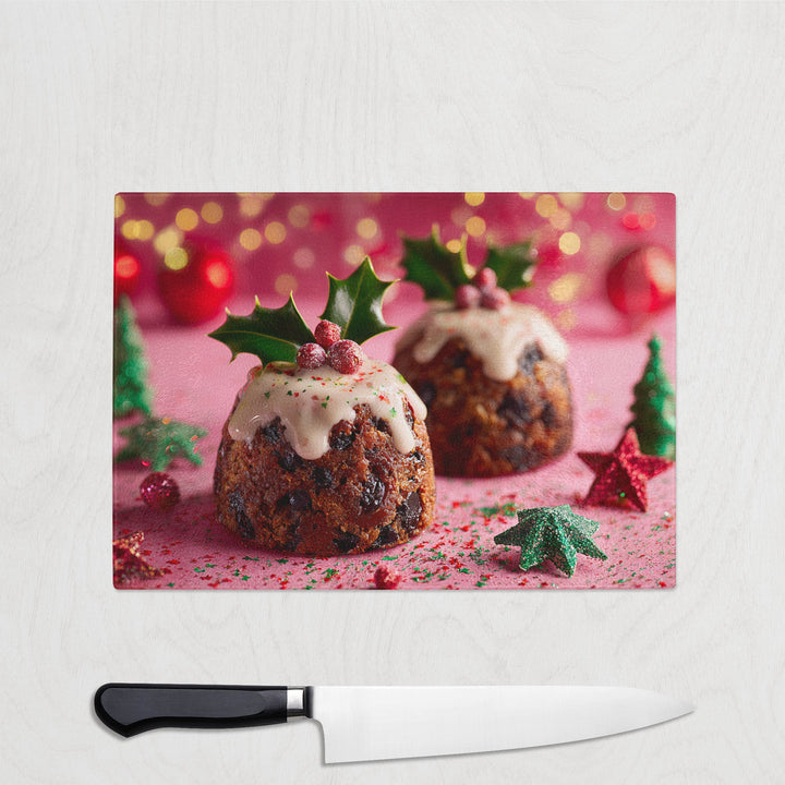 Christmas pudding with holly on a chopping board with a knife in front