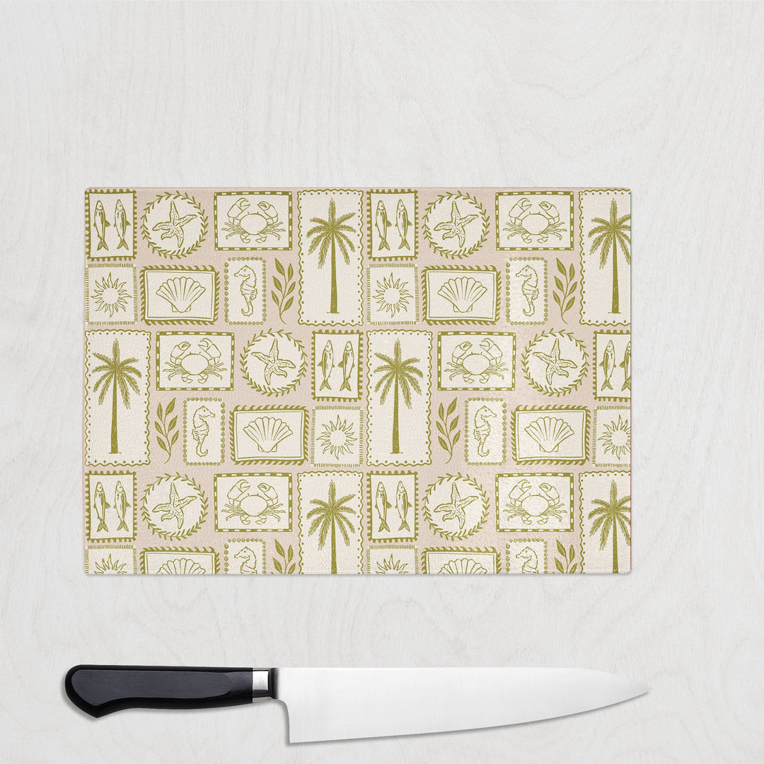 Coastal Chic glass chopping board with vintage stamps of palms, shells, seahorses and starfish