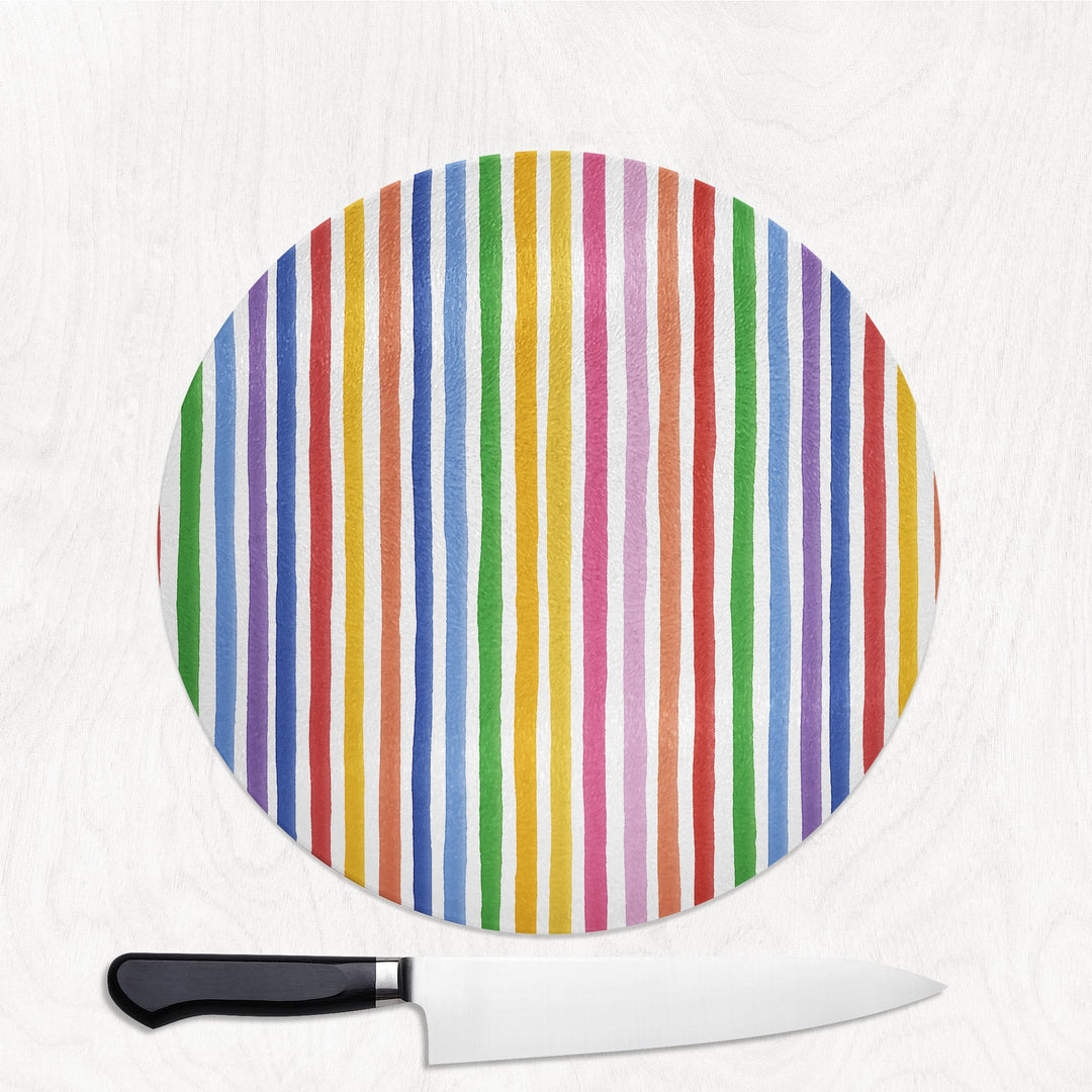 Colourful Stripes round glass chopping board with bold hand-painted rainbow stripes