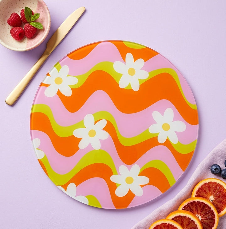 Colorful wavy-patterned plate with flowers on a light purple background