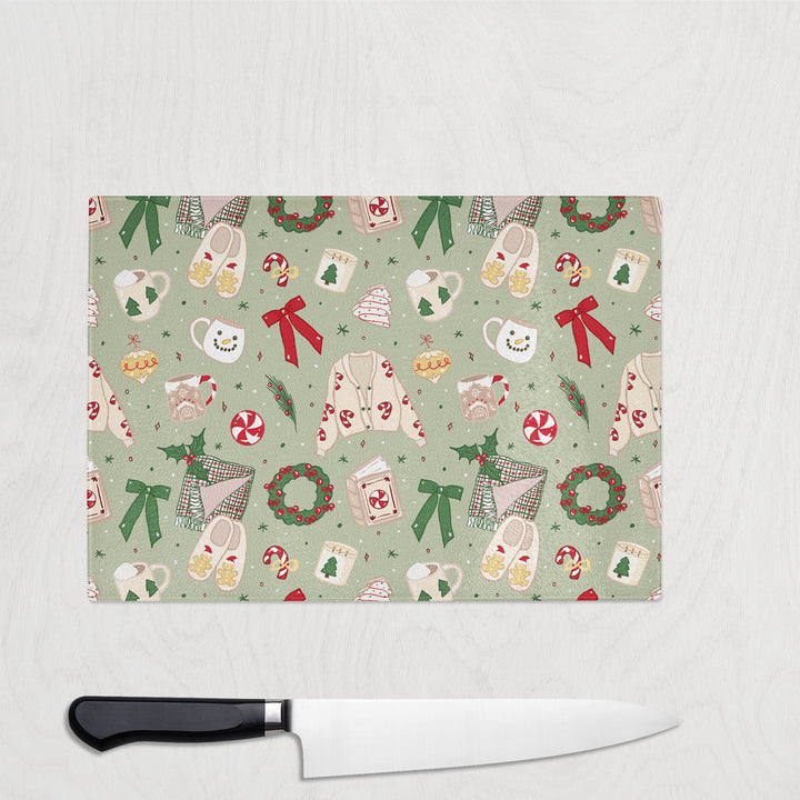 Christmas-themed cutting board with a knife on a white background