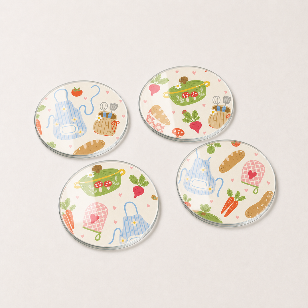 Four round glass coasters with colorful illustrations on a light gray background