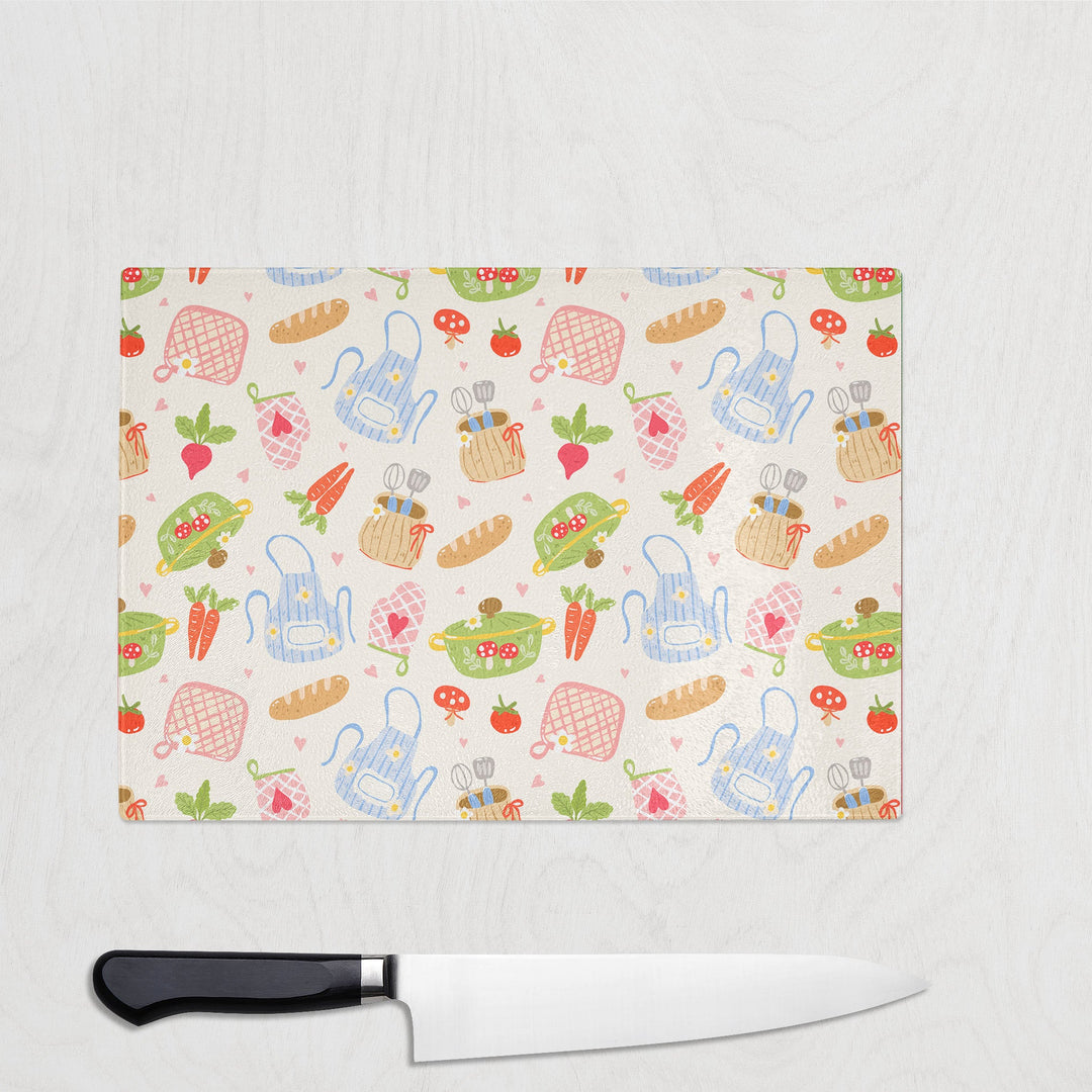 Country Kitchen glass chopping board with aprons, pots, bread and kitchen veg