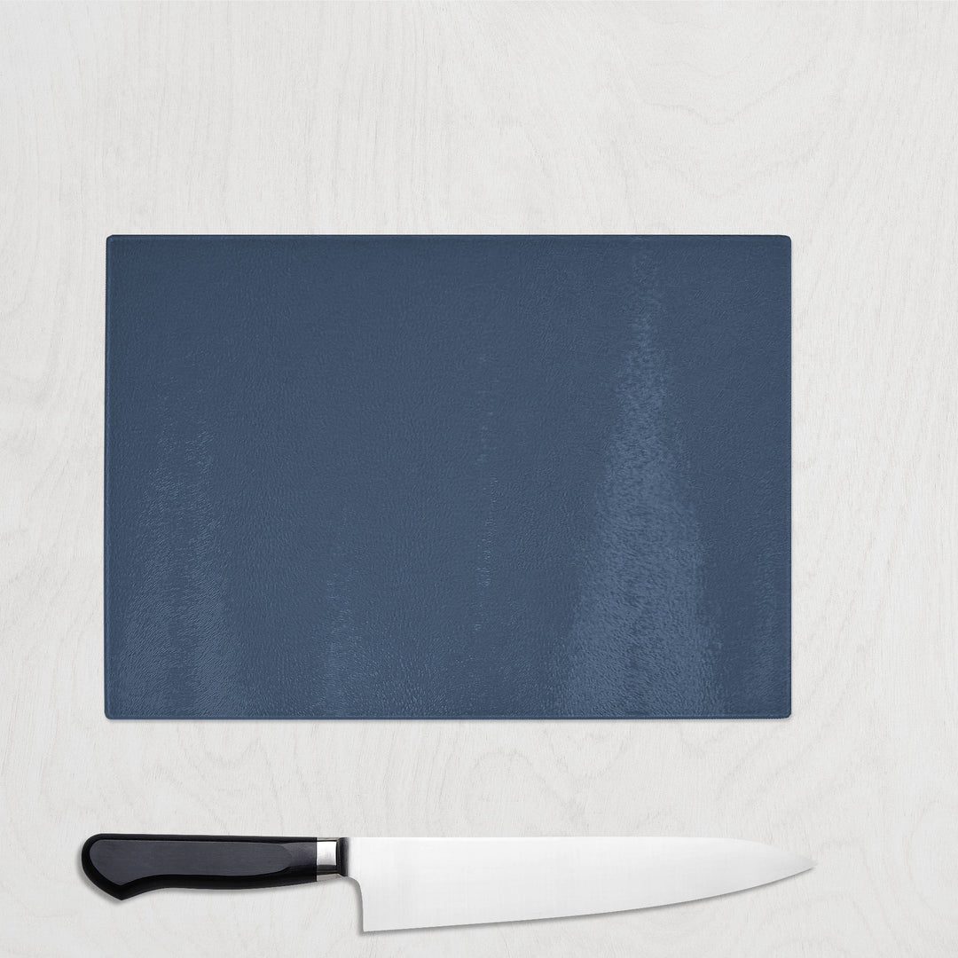Blue Navy cutting board with a knife on a light gray background