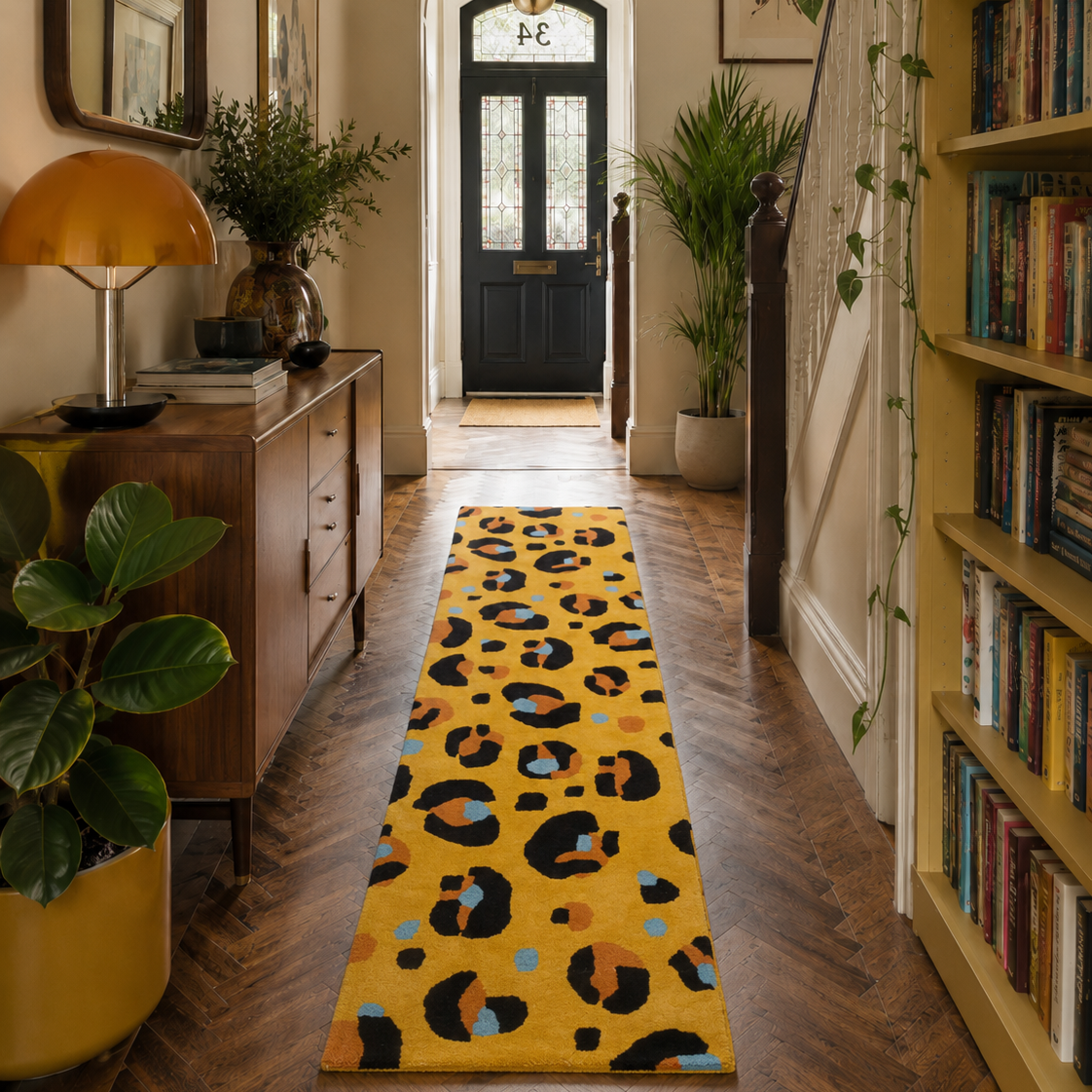 Hallway with a yellow leopard print rug, bookshelf, and decorative items.