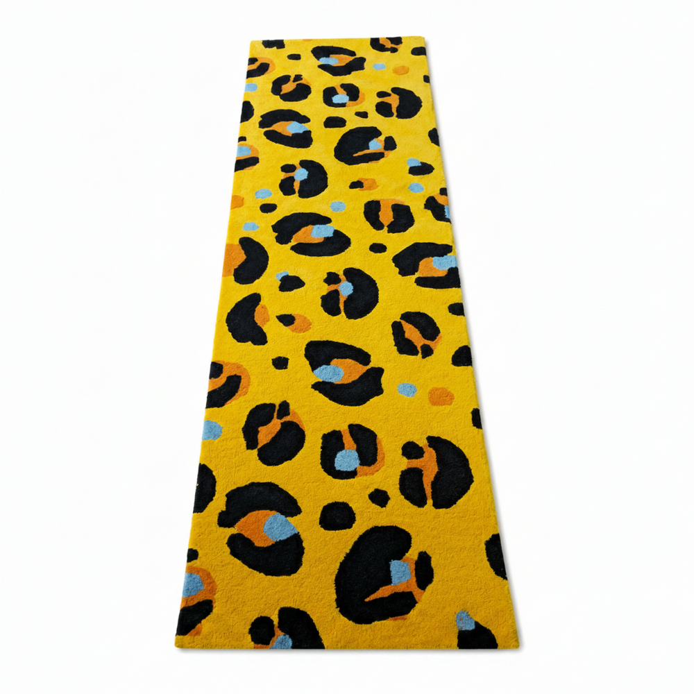 Yellow leopard print rug with black, orange, and blue leopard print pattern on a white background