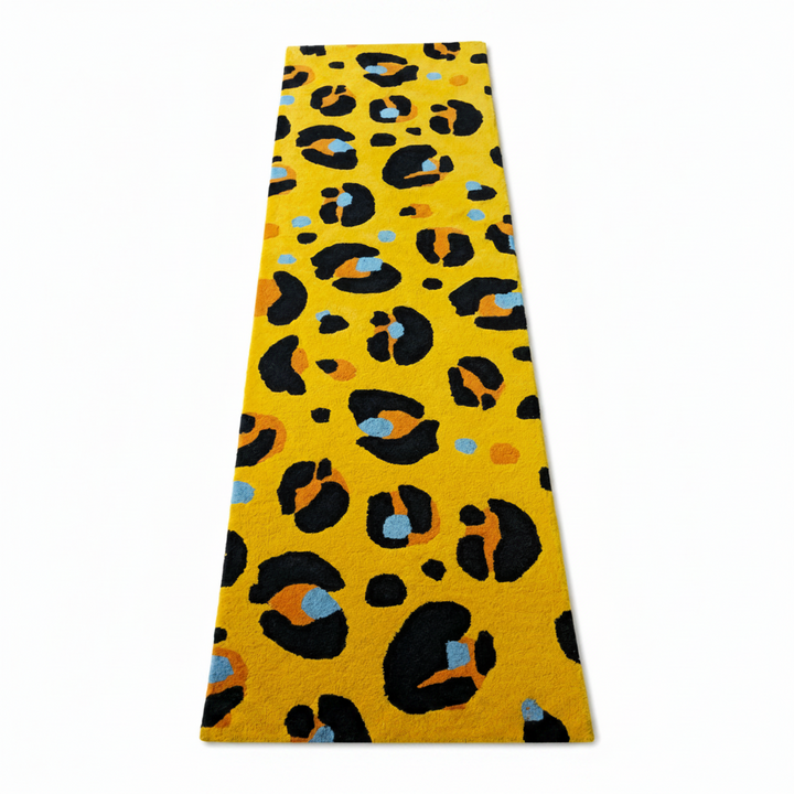 Yellow leopard print rug with black, orange, and blue leopard print pattern on a white background