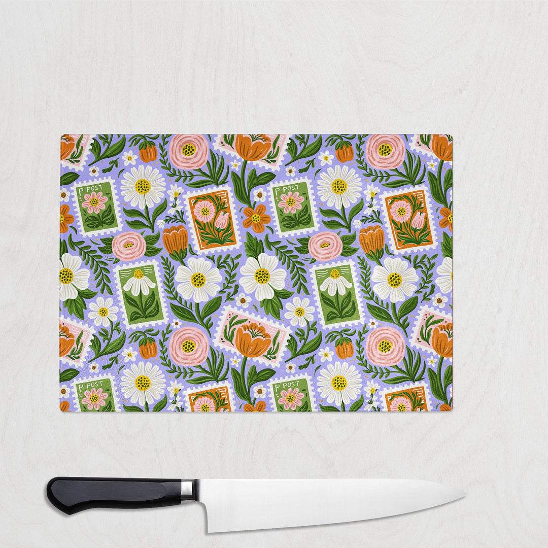Floral Stamps glass chopping board with postage-stamp florals, daisies and blooms