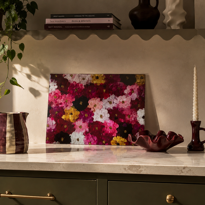 Floral Glass worktop saver on a shelf with decorative items bowl, jug and candle stick.