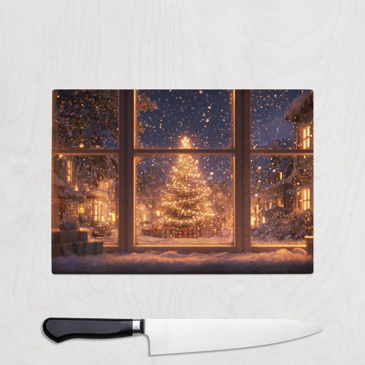 Glass chopping board with glowing Christmas tree through frosted window, twinkling lights, and snow-covered houses