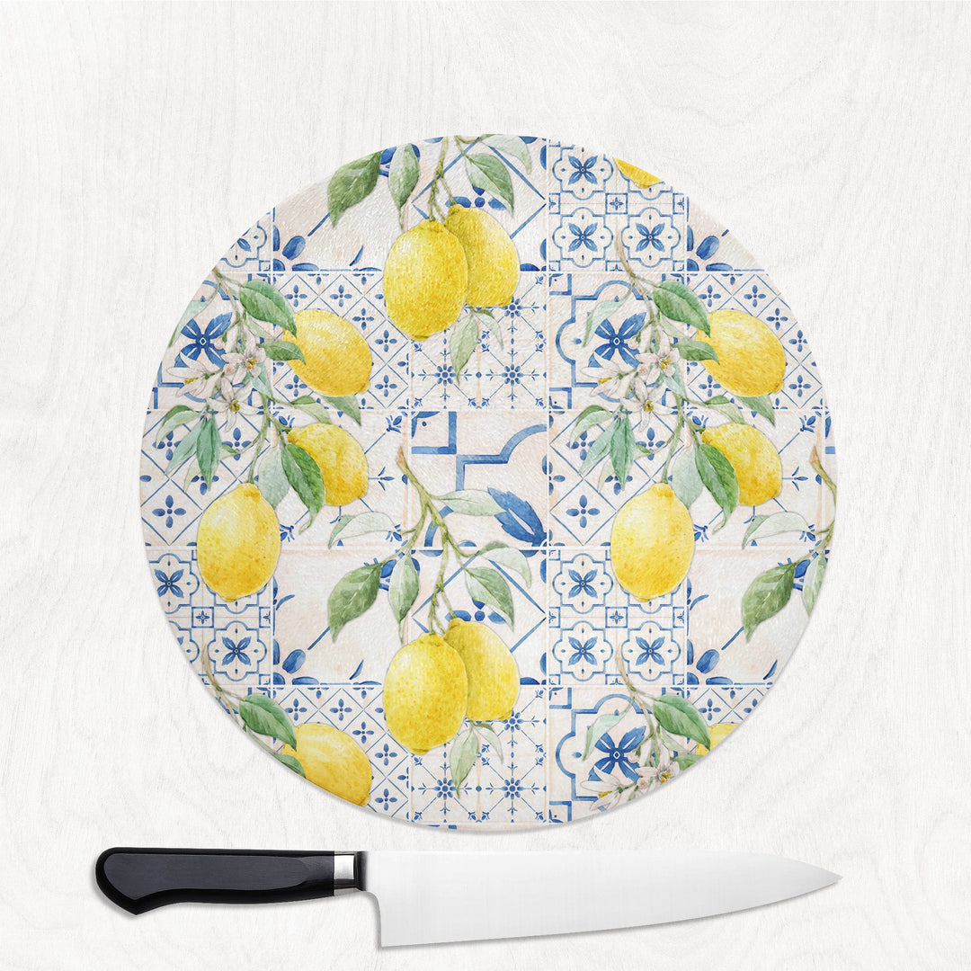 Round cutting board with lemon and tile pattern on a white background