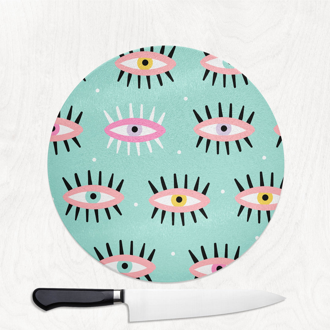 Round cutting board with eye pattern on a white background