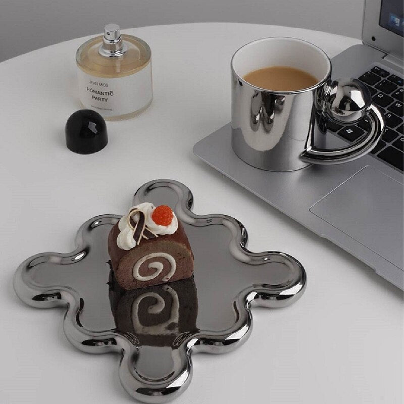 Chrome Coffee Mug With Rotating Ball Handle And Swirly Silver Saucer For Cup