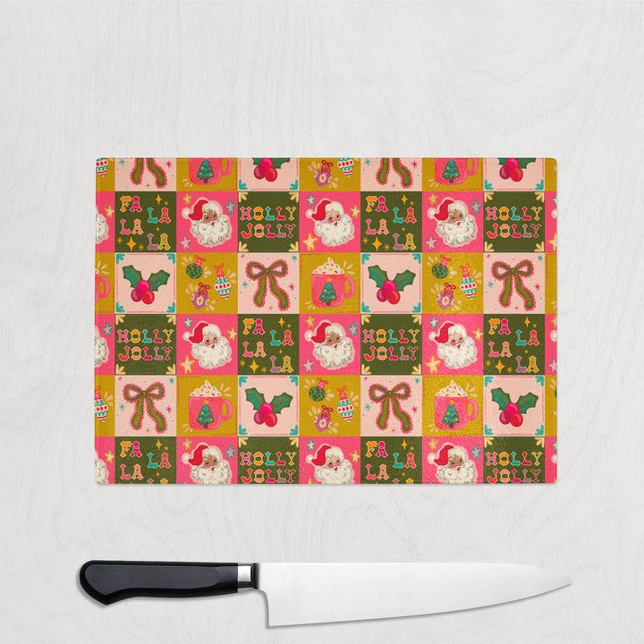 Christmas-themed cutting board with a knife on a white background
