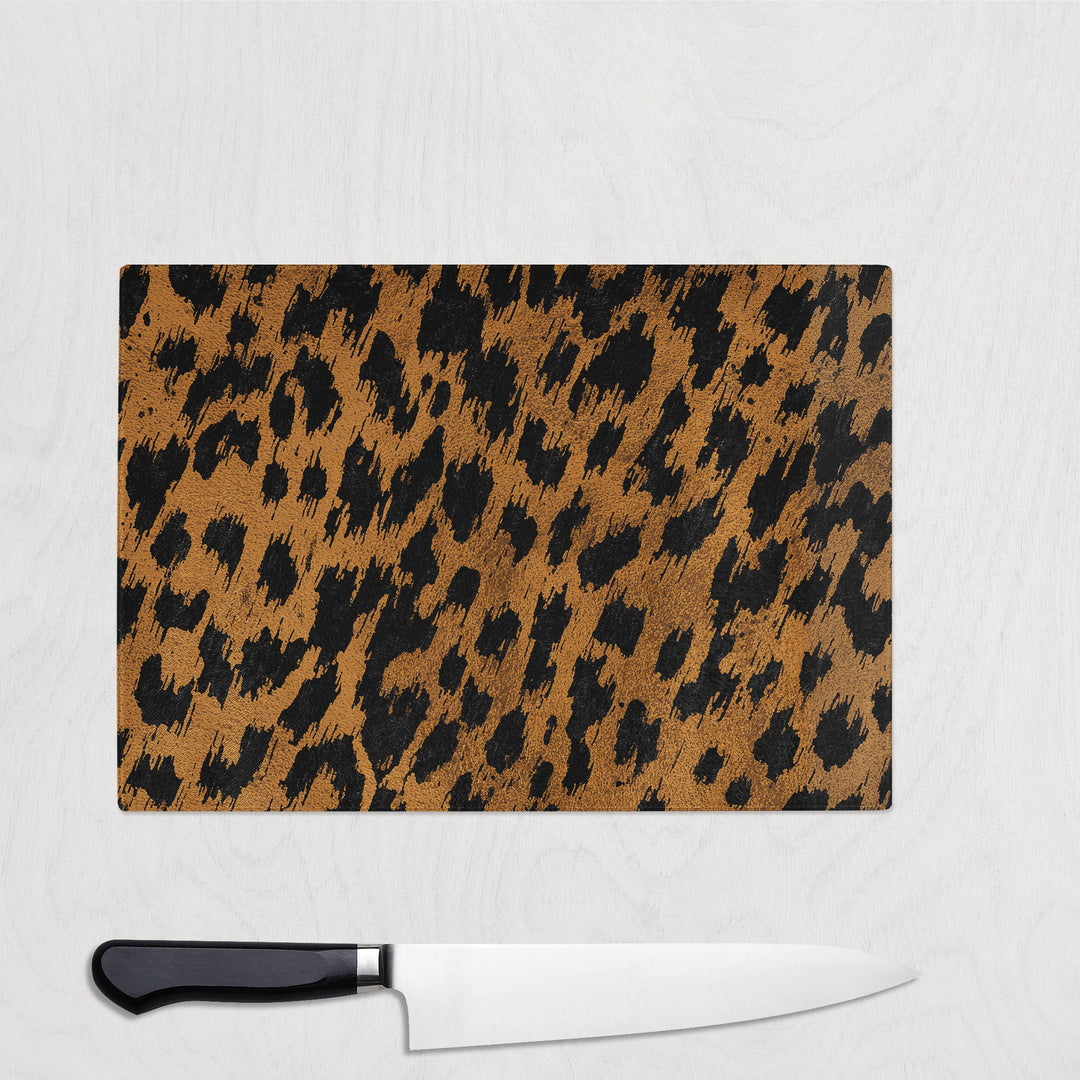 Leopard print glass chopping board on light background
