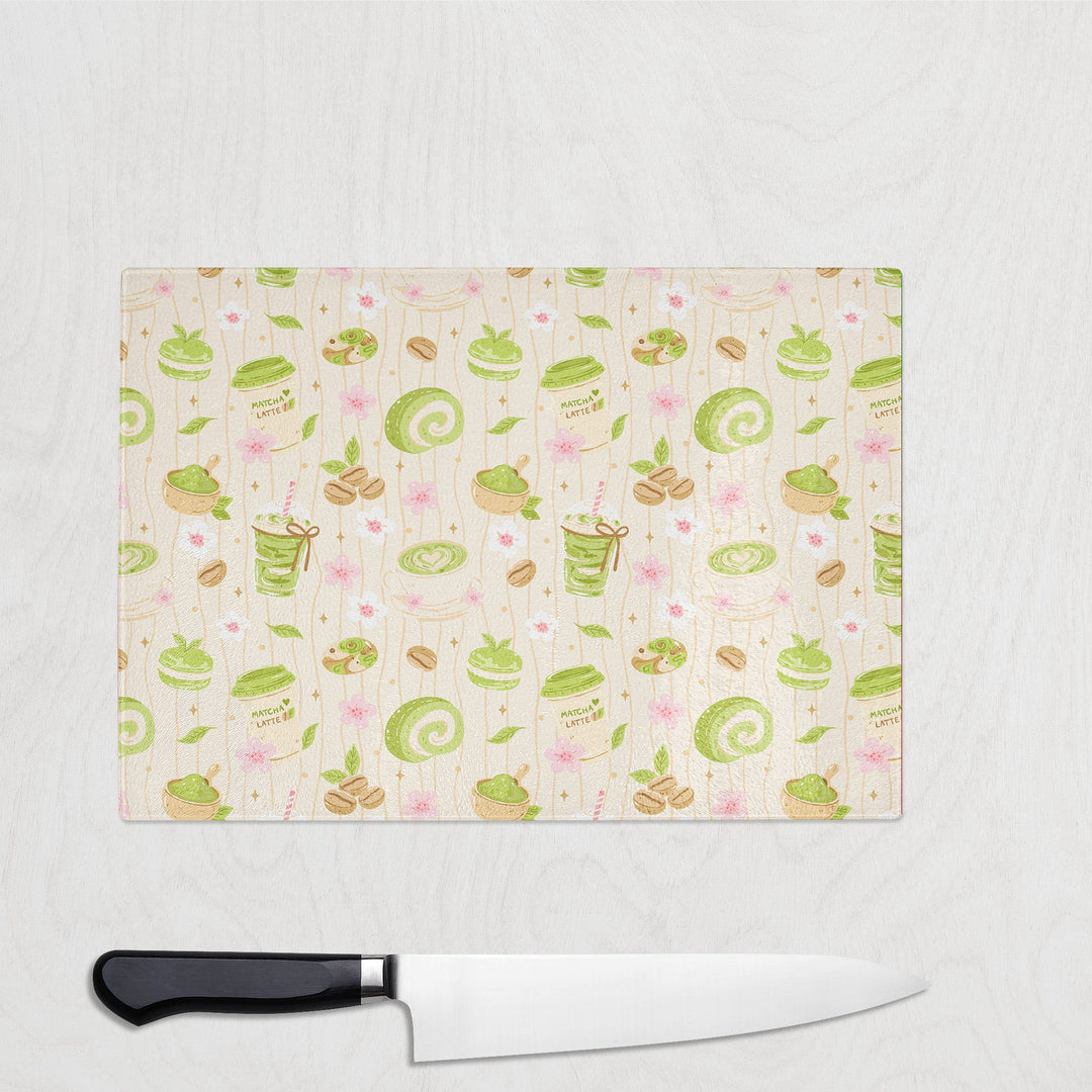 Matcha and Cake glass chopping board with matcha lattes, swiss rolls and cherry blossom