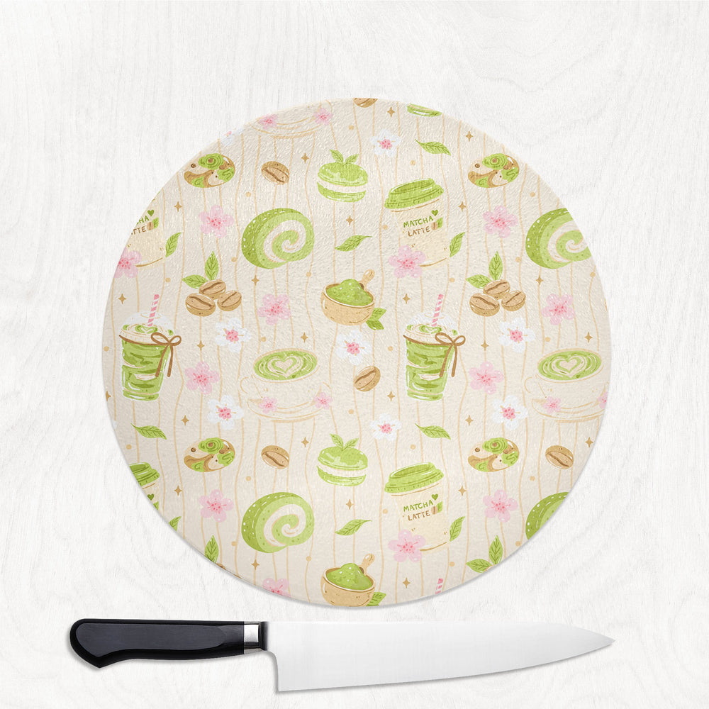 Matcha and Cake round glass chopping board with matcha lattes, swiss rolls and cherry blossom