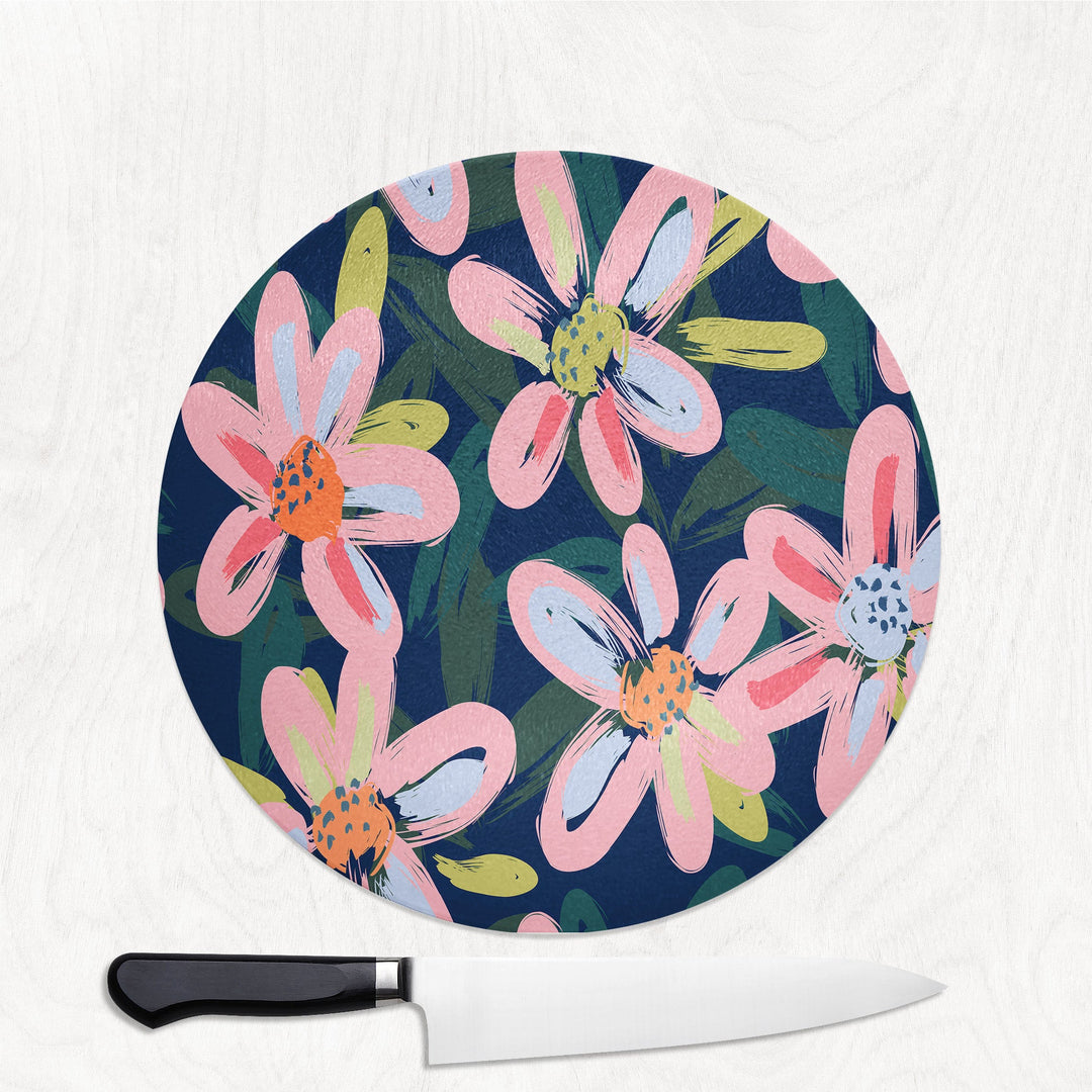 Floral-patterned cutting board with a knife on a white background