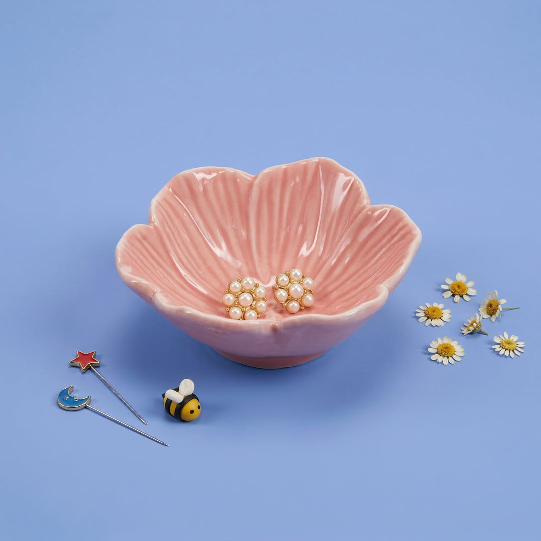 Pink ceramic bowl with pearls on a blue background