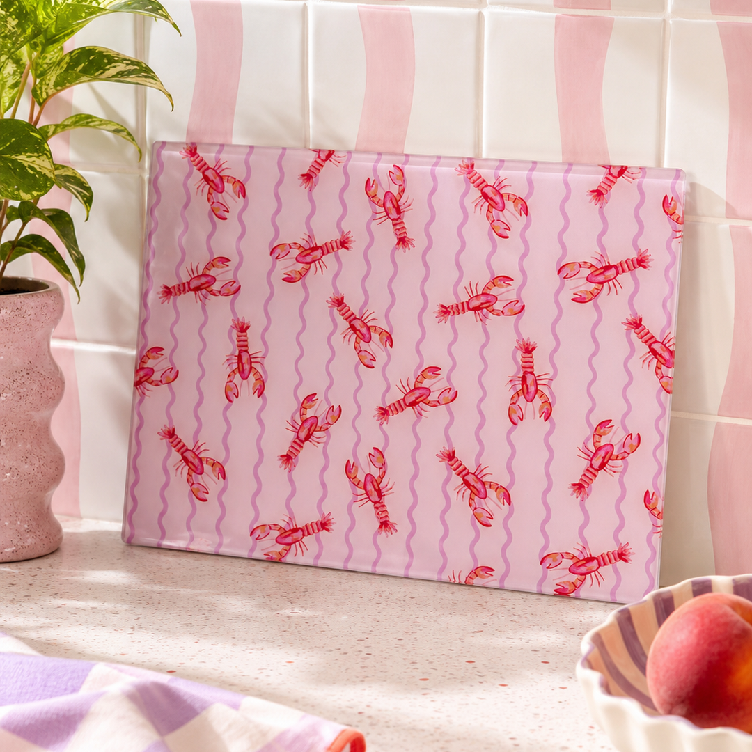 Pink lobster wave cutting board with red lobster pattern on a kitchen counter