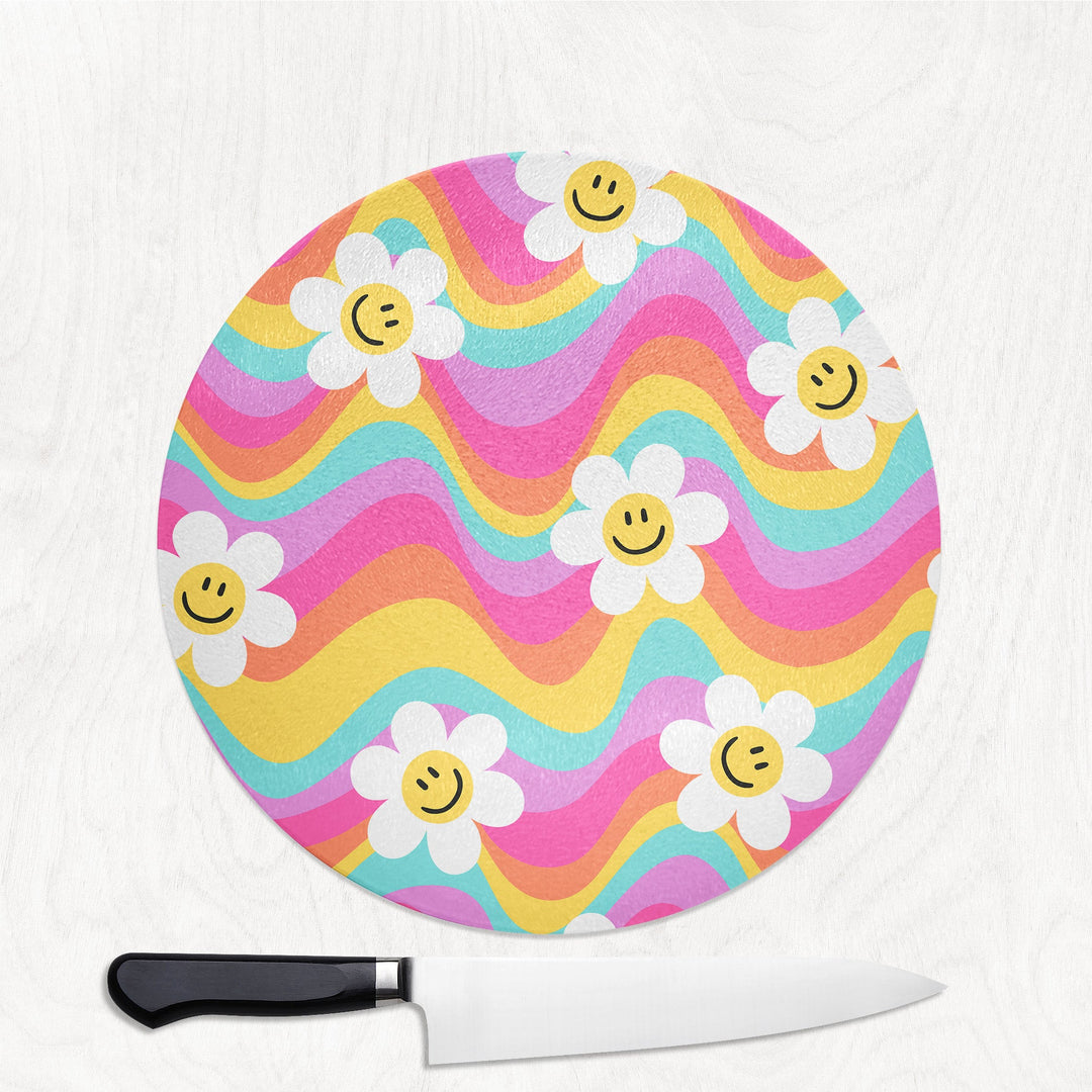 Colorful rainbow wavy 90s y2k cutting board with smiley face flowers and a knife on a white background