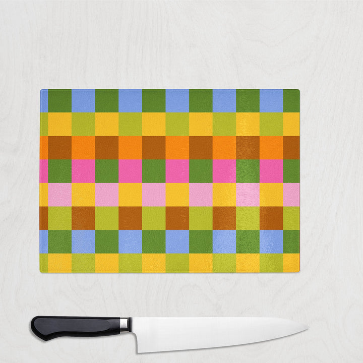 Saffron Plaid glass chopping board in warm ochre and terracotta check