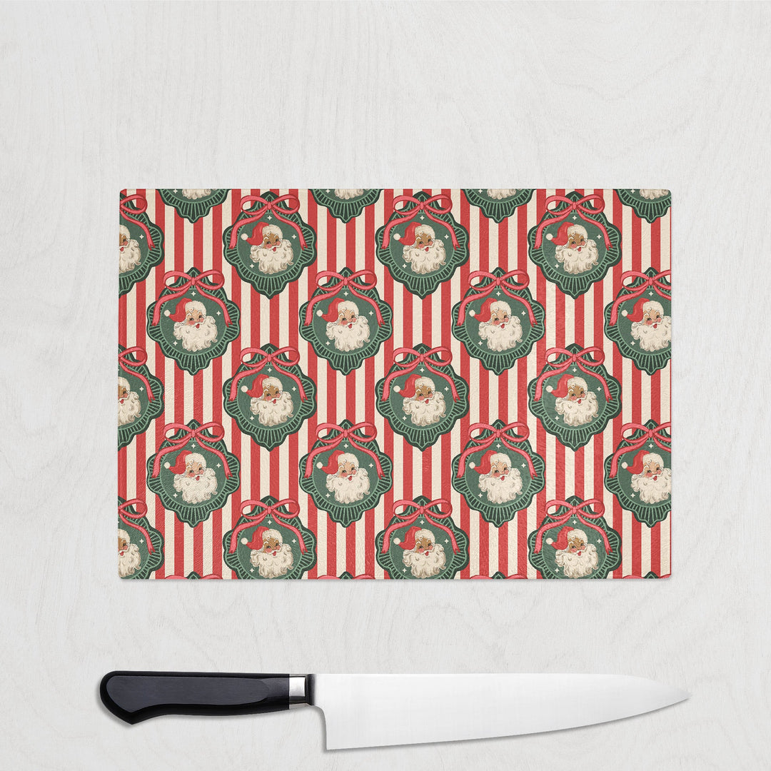 Christmas-themed cutting board with Santa Claus pattern on a white background