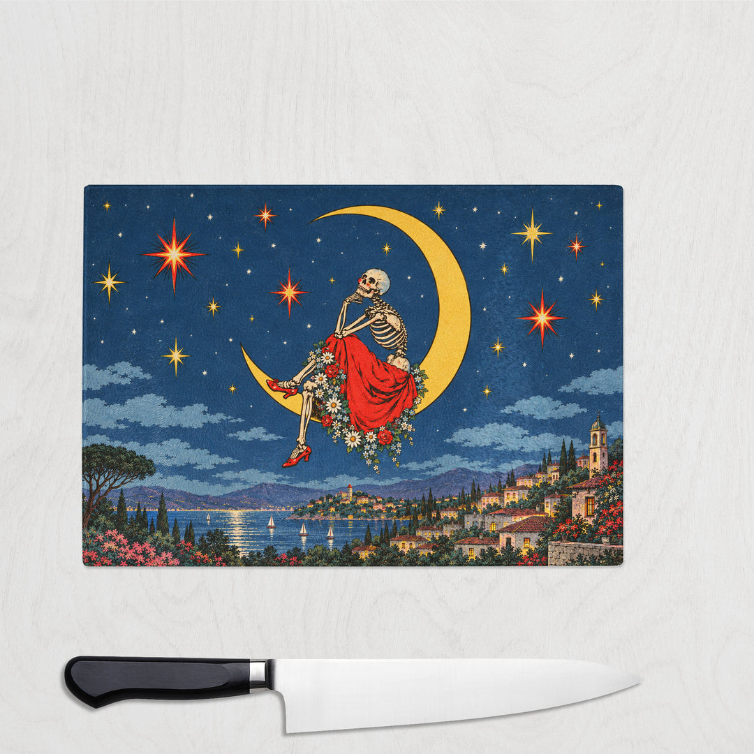 Skeleton Star Gaze glass chopping board with a skeleton in a red ballgown sitting on a crescent moon above a starry coastal town