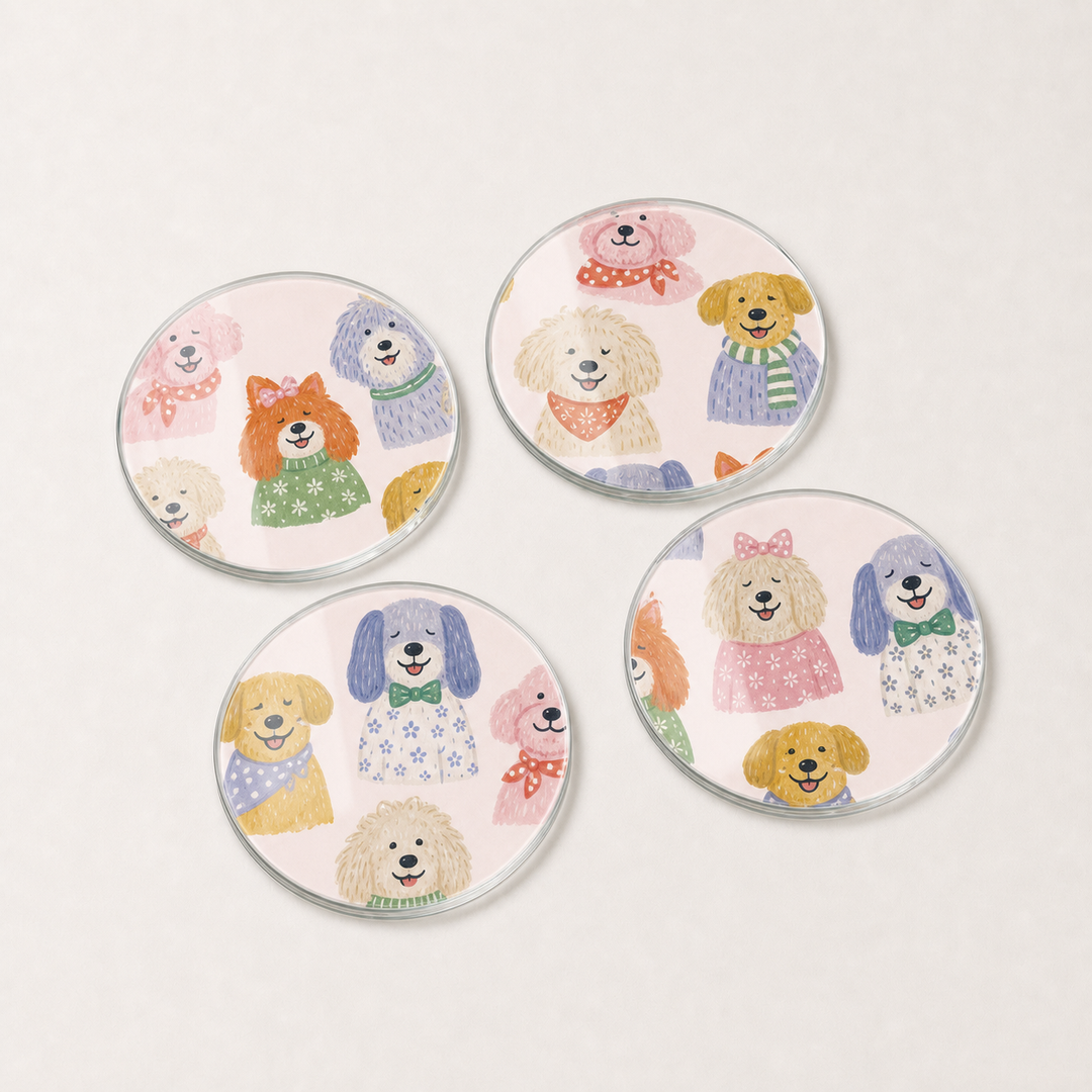 Four round glass coasters with illustrations of dogs on a light gray background