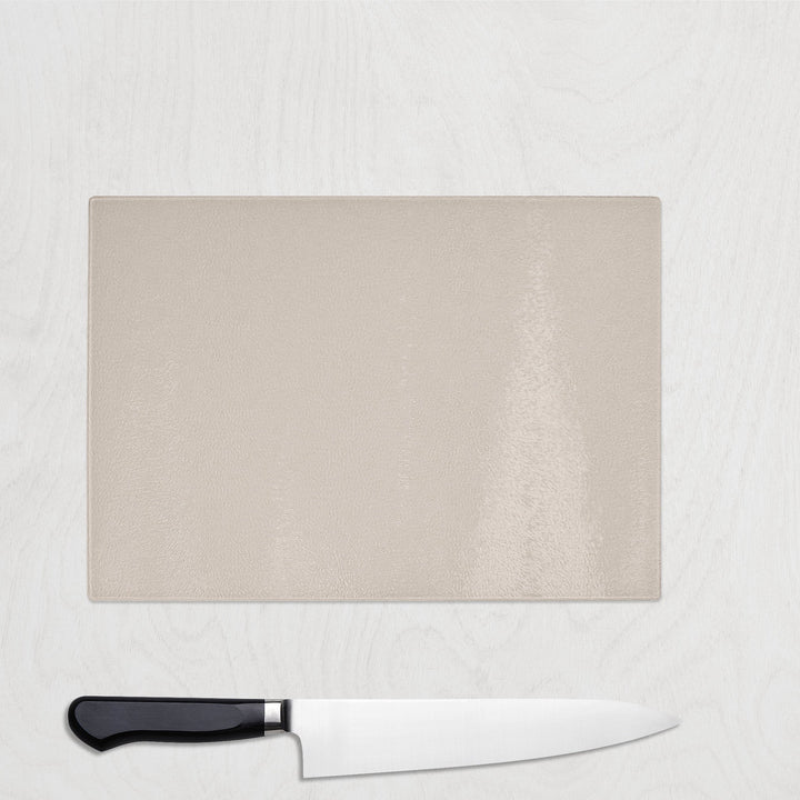 Cream Chopping board with a knife on a light gray background