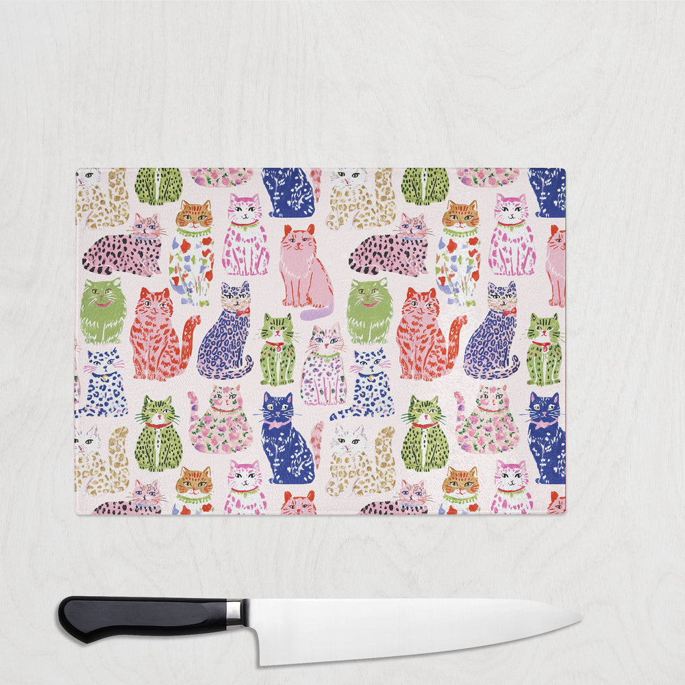 Spotty Cats glass chopping board with playful spotty and leopard-print cats