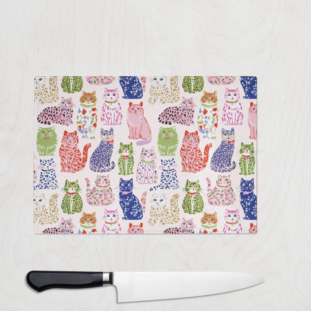 Spotty Cats glass chopping board with playful spotty and leopard-print cats
