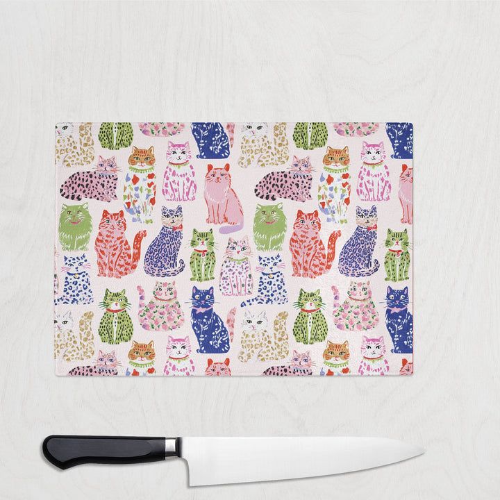 Spotty Cats glass chopping board with playful spotty and leopard-print cats
