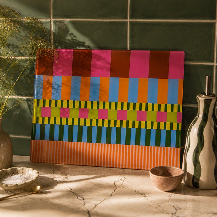 Studio check worktop saver by yililo leaned against a green tile with a green swirl oil bottle 