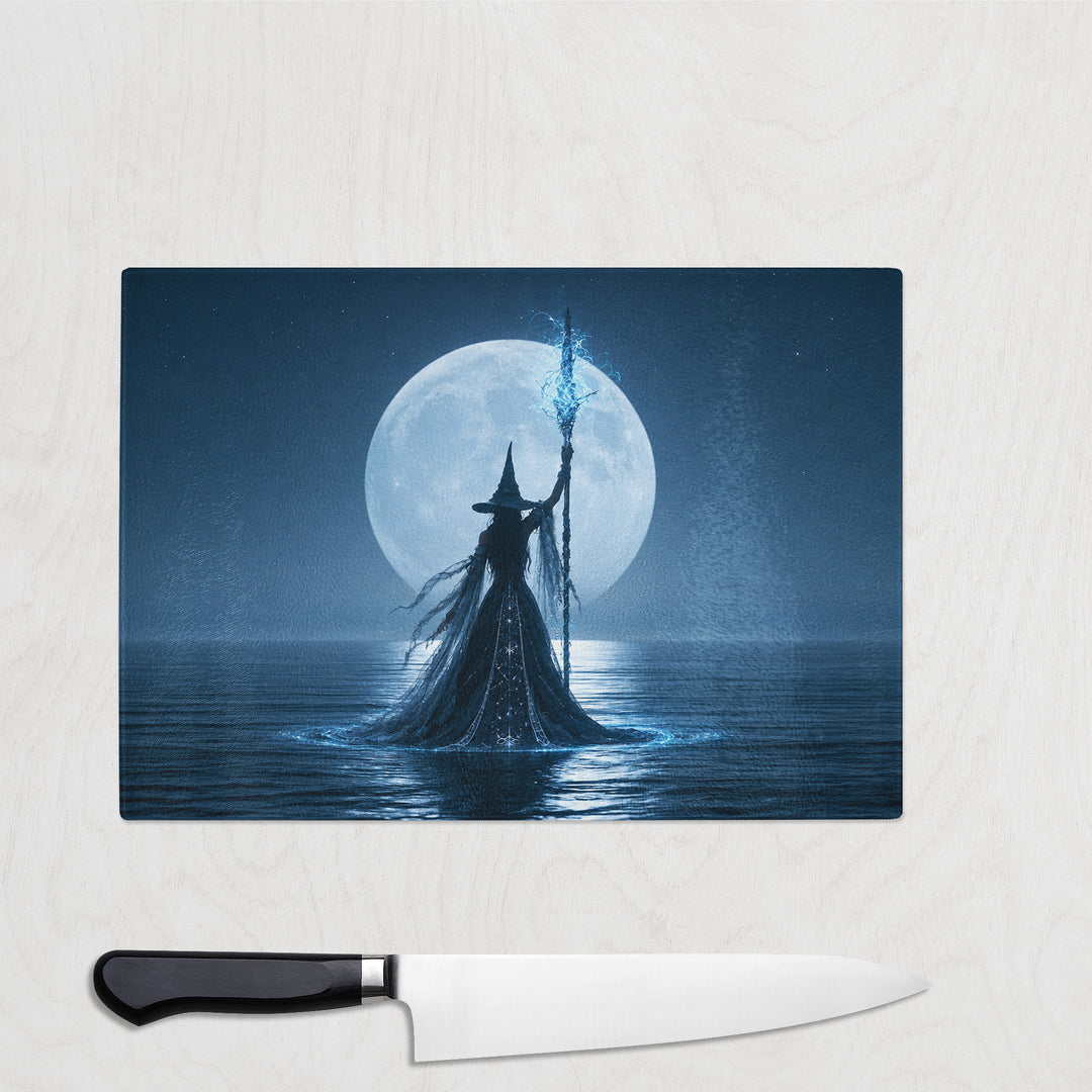 The Sorceress Spell glass chopping board with a witch standing in moonlit water, staff raised and crackling with blue light