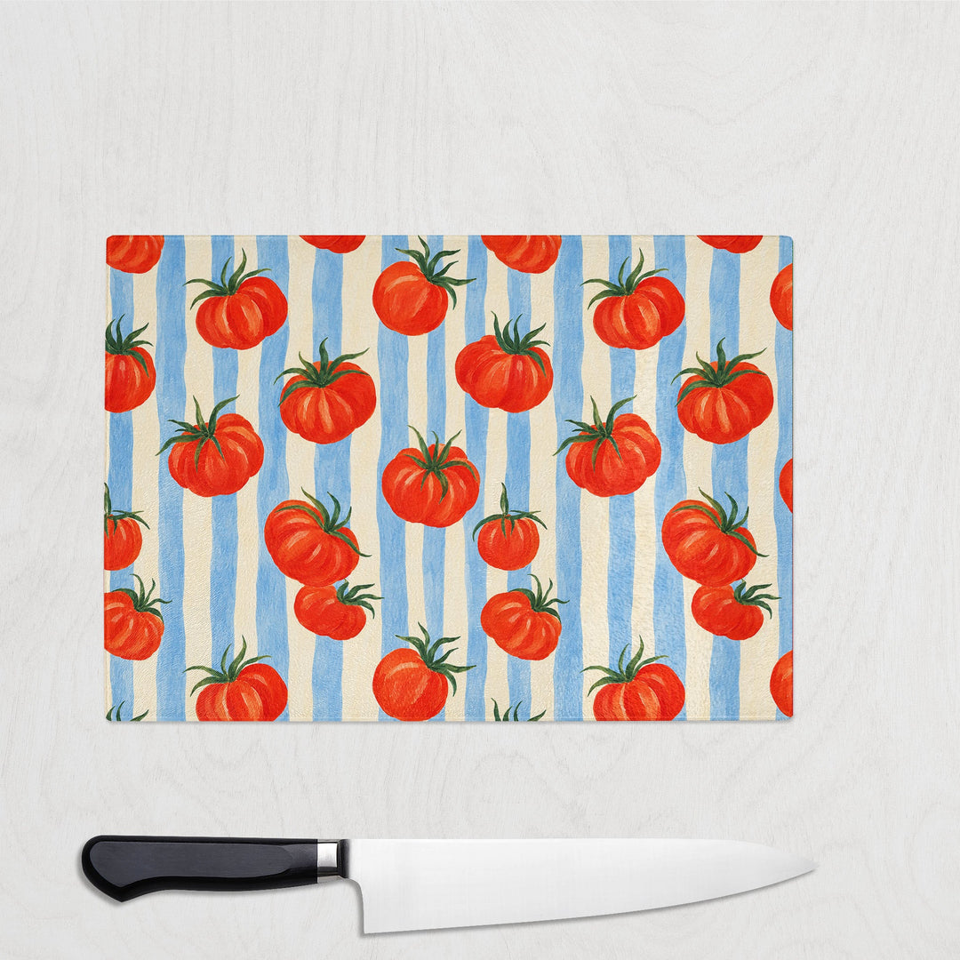 Tomato and Stripes glass chopping board with plump tomatoes on blue and cream stripes