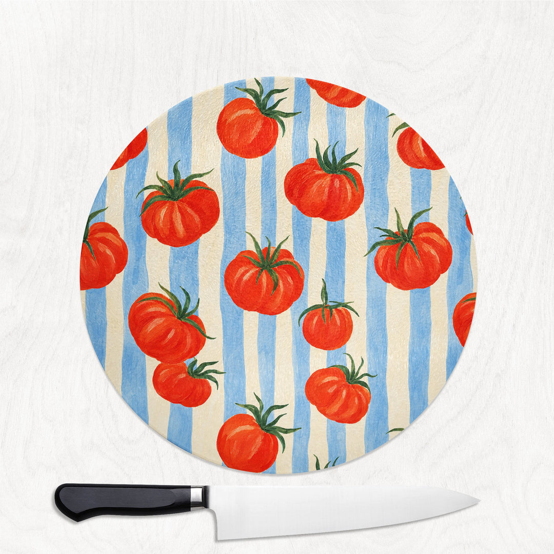 Tomato and Stripes round glass chopping board with plump tomatoes on blue and cream stripes