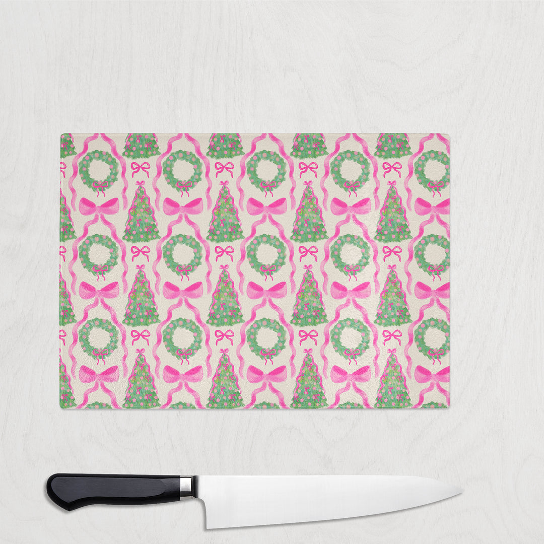 Christmas-themed cutting board with a knife on a white background